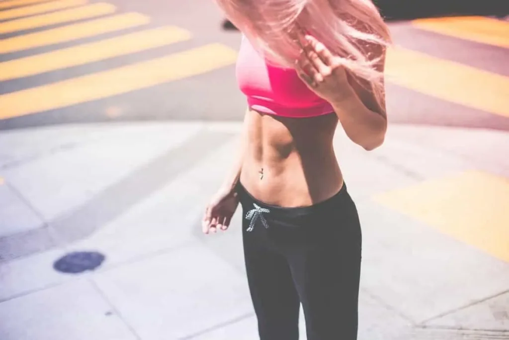 Woman with toned stomach after LA-EMS Body Sculpting Treatment Small Heath